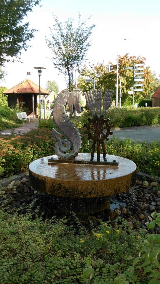 Brunnen mit Skulptur vor dem Rathaus.